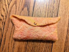 "This handcrafted clutch can hold one's essentials. Use it as a clutch, a cellphone bag, makeup bag, or eyeglass case. It measures about 9\" x 4\". It was handcrafted and seamlease from wool roving and silk using a wet felting process. An orange pearlescent snap is the closure. The purse is in shades of orange - peach, apricot, creamsicle, coral. This is a one of a kind piece of functional art." Orange Pouch Clutch For Daily Use, Orange Rectangular Pouch For Gift, Rectangular Orange Pouch For Gifts, Orange Pouch Clutch For Everyday Use, Rectangular Orange Clutch As Gift, Rectangular Orange Clutch For Gift, Orange Pouch Clutch As Gift, Orange Pouch Clutch For Gift, Orange Rectangular Pouch For Daily Use