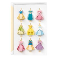 a card with paper cut outs of princess dresses