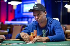 a man sitting at a table with cards in front of him