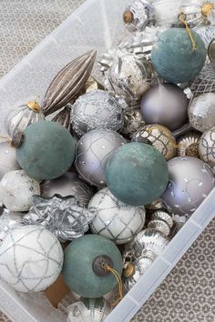 a plastic container filled with ornaments on top of a table