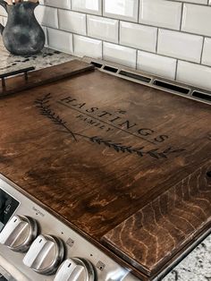 a wooden cutting board sitting on top of an oven