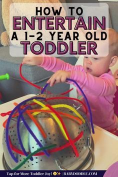 a toddler playing with a toy on top of a table