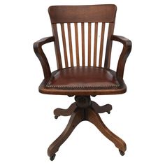 an old fashioned wooden chair with leather upholstered seat