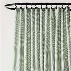 a green curtain with wavy lines on it