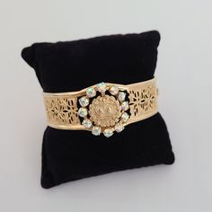 Stunning and very elegant vintage bracelet gold-tone filigree cuff with Aurora Borealis crystals. Has an unusual design with a round element -a crown and a sword.  Exceptional shine due to Aurora Borealis crystals. In excellent vintage condition. For new arrivals check out the store's Instagram account https://www.instagram.com/helensjewellerybox/ All jewelry is photographed in natural light and may have light scratches due to age and wear. Thank you for looking and if you have any questions ple Ornate Gold Bracelets With Jewels, Vintage Gold Jewelry With Crown Design, Ornate Jeweled Gold Bracelet, Ornate Gold Jeweled Bracelet, Victorian Gold Jeweled Bracelets, Ornate Gold Jeweled Bracelets, Gold Jeweled Crown Jewelry, Vintage Jeweled Gold Cuff Bracelet, Luxury Traditional Filigree Bracelets