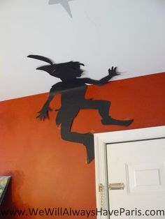 a paper cut out of a person jumping in the air with a star above them