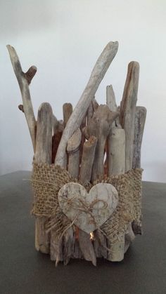 driftwood is wrapped in burlap and tied with twine, on top of a table