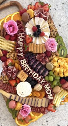 a birthday cake made out of fruits, cheeses and meats with the words happy birthday written on it