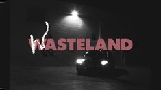 a black and white photo with the words wasteland written in red on it's side