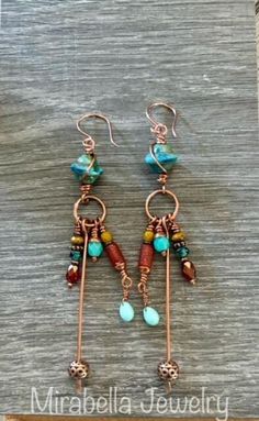 Pretty blue czech glass beads are wire wrapped and have a copper ring below with lots of colorful Czech glass and copper beads dangling from. Copper ear wires and a  protective coating finish off these beautiful earrings. Total length is just over 4" long. Bohemian Copper Beaded Earrings, Bohemian Copper Beaded Earrings With Round Beads, Unique Copper Earrings With Dangling Beads, Bohemian Hand Wrapped Copper Earrings, Bohemian Wire Wrapped Copper Earrings, Bohemian Wire Wrapped Beaded Metal Earrings, Copper Beaded Dangle Earrings With Dangling Beads, Bohemian Wire Wrapped Metal Beaded Earrings, Bohemian Hand-wrapped Copper Wire Earrings