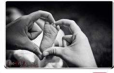 two hands making a heart shape with their fingers in black and white, while the other hand is holding another's finger