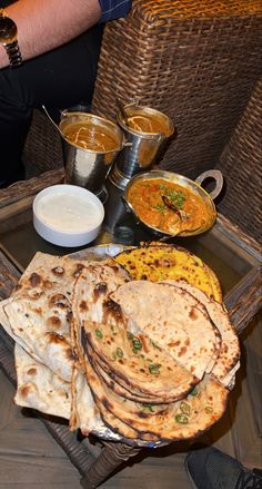 a tray filled with lots of food on top of a table