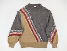 "Stunning 80s vintage pattern knit warm women's sweater / jumper by Bogner. Diagonally striped / fair isle patterned in grey, mustard, beige, red, white. Featuring dropped shoulders, stud button shoulder, batwing sleeves. Made in West Germany. SIZE TAG: D42 FABRIC CONTENT: 30% wool 25% mohair 25% polyamide 20% alpaca CONDITION: excellent, no flaws to note. MEASUREMENTS (taken flat, not doubled): Bust: 57 cm / 22 1/2\" Hem: 42 cm / 16 1/2\" Length: 67 cm / 26 1/2\" Please do not hesitate to conta Retro Fair Isle Pattern Winter Tops, Vintage Fall Tops With Fair Isle Pattern, Vintage Fair Isle Pattern Tops For Fall, Vintage Fair Isle Tops For Fall, Vintage Jacquard Knit Winter Sweater, Vintage Jacquard Knit Sweater For Winter, Vintage Turtleneck Winter Tops, Vintage Turtleneck Tops For Winter, Vintage Jacquard Knit Winter Tops