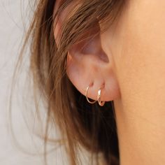 Add some sunny sparkle to your ear with the Tiny Huggie Post Hoop. It's the perfect little pick-me-up for your lobes, crafted from pure 14k gold for a happiness-inducing shimmer. comes with a 14k gold classic earring back sold as a single hoop, unless you select a different quantity from the drop down menu hoops measure 9.7mm in diameter post is 20g these earrings are made entirely out of solid 14k gold, so they are safe for sensitive ears! These are made to order, please check here for updated Dainty Stackable 14k Gold Earrings, Dainty 14k Gold Stackable Earrings, Everyday Small Stackable Hoop Earrings, Dainty Stackable Huggie Earrings, Dainty Stackable Round Huggie Earrings, Stackable Yellow Gold Huggie Earrings In Sterling Silver, Stackable Sterling Silver Hoop Earrings, Stackable Sterling Silver Hoop Earrings Fine Jewelry, Yellow Gold Stackable Huggie Earrings In Sterling Silver