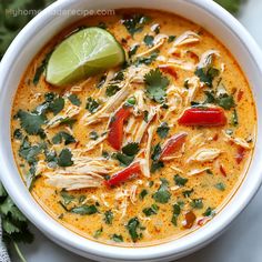 a white bowl filled with soup and garnished with cilantro