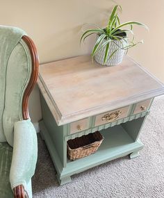 a chair with a plant on top of it next to a small table and shelf