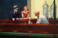 two men and a woman sitting at a bar