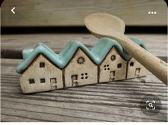 a wooden spoon sitting on top of a row of houses