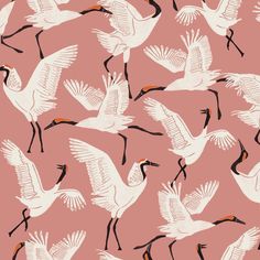 a flock of white birds flying across a pink sky