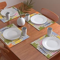 the table is set with white plates and placemats