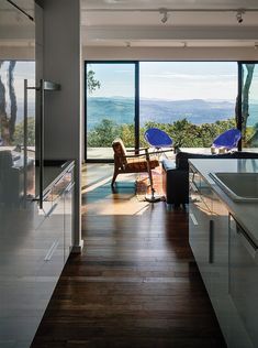 an open kitchen and living room with sliding glass doors that look out onto the mountains