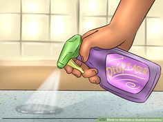 a person is spraying disinfection on the counter top with a spray bottle