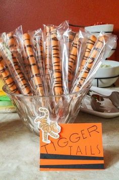 there are many cookies wrapped in plastic and on the table is a sign that says tiger tails