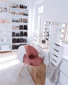 an image of a room with white furniture and shoes on the shelves in front of it