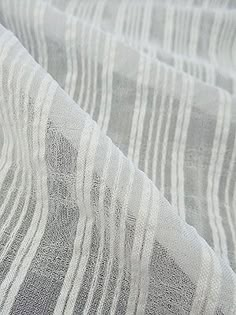 an image of a white and grey fabric textured with thin lines on the surface