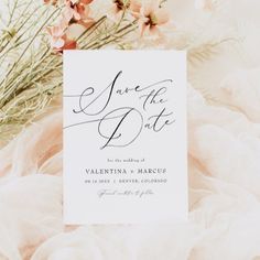 a wedding save the date card with pink flowers and tulle around it on a white background