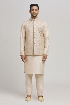 Ivory bundi with thread embroidered chevron patterns. Comes with inner kurta and pant. - Aza Fashions Ceremonial Cream Nehru Jacket With Zari Work, Transitional Beige Bandhgala With Intricate Embroidery, Beige Nehru Jacket With Traditional Drape For Festive Occasions, Beige Nehru Jacket For Festive Occasions, Festive Beige Nehru Jacket With Long Sleeves, Festive Beige Long Sleeve Nehru Jacket, Festive Long Sleeve Beige Nehru Jacket, Festive Beige Nehru Jacket, Traditional Beige Nehru Jacket With Traditional Drape