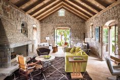 a living room filled with furniture and stone walls