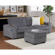 a living room with a gray couch and ottoman