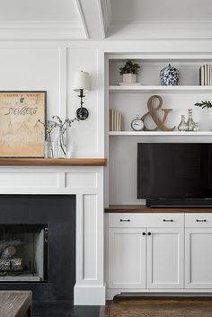 an image of a living room with fireplace and entertainment center on the wall above it