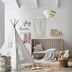 a child's room with a teepee and toys