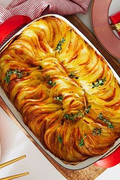 a casserole dish with potatoes and parsley on top