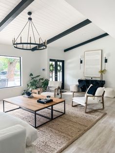 a living room filled with furniture and a wooden coffee table on top of a rug