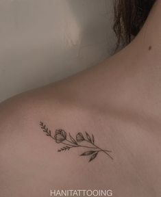 a woman's chest with flowers and leaves tattoo on the left side of her body