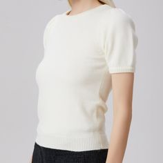 This knit top is structured with ribbed edges on the collar, sleeves and hem. It is structured with gathers on the top sleeves and features a soft and comfortable stretch material. An elegant and timeless piece that is suitable for mid-season and energizes rather classic looks such as pants/blazer or skirt/jacket, for everyday and city occasions. Main material: 52% Acrylic, 28% Polyamide, 20% Pbt. Washing temperature 30° maximum in delicate cycle. Low ironing temperature / bleaching prohibited. September Birthstone Jewelry, August Birthstone Jewelry, July Birthstone Jewelry, Versatile Outfits, Gifts For New Mums, Pearl Jewellery Earrings, August Birth Stone, White Short, Independent Designers Fashion