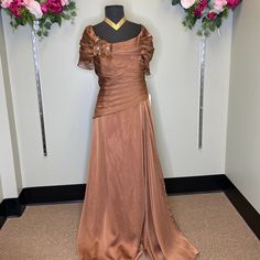 a dress on display in a room with flowers