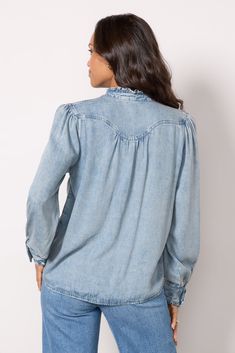 Finished with ruffles at the collar and cuffs, the Alanna Shirt by Rails is crafted in soft lyocell-blend denim with a seamed yoke, front snap closures, and long puff sleeves. Tuck into cargo pants, or pair with jeans for a denim-on-denim look. | RAILS Women's Alanna Shirt, Size XS, Blue Long Sleeve Denim Blue Top With Frayed Hem, Denim Blue Long Sleeve Top With Frayed Hem, Long Sleeve Washed Blue Denim Top With Frayed Hem, Washed Blue Long Sleeve Denim Top With Frayed Hem, Spring Long Sleeve Tencel Tops, Casual Shirt With Ruffled Collar For Fall, Casual Denim Blouse With Ruffles, Casual Denim Ruffle Blouse, Light Wash Long Sleeve Top With Frayed Hem