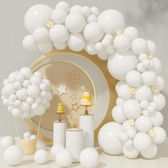 a white and gold birthday party with balloons, cake, candles and stars on the table