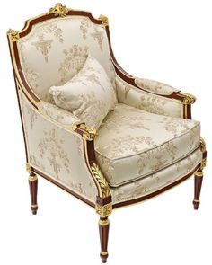 an ornately decorated chair with two pillows on it's back and armrests