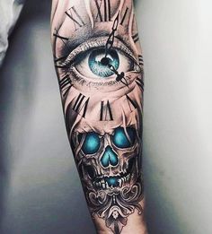 a man's arm with a clock and eye tattoo on it