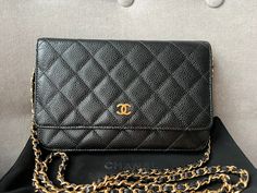 Overview Chanel Wallet on Chain in Black Caviar Leather with Gold Hardware. The ultimate evening style, the classic Chanel WOC is timeless and features the CC hardware detailing on the front flap. The caviar leather is robust and resilient meaning you won't have to baby this piece. Perfect for evening wear or night out to carry the essentials. Can be carried as a handheld clutch with the chain tucked inside, or over shoulder or cross body. The classic WOC is highly sought after and now sells at Classic Gold Wallet On Chain For Business, Classic Formal Wallet With Chain Strap, Elegant Leather Wallet With Chain Detail, Elegant Leather Wallet With Chain, Elegant Leather Wallets With Chain, Classic Chain Wallet For Formal Occasions, Classic Chain Wallets For Formal Occasions, Chanel Wallet On Chain, Chanel Woc