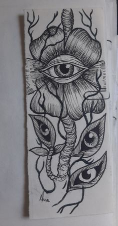 a drawing of an eye surrounded by leaves and feathers on a piece of white paper