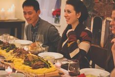 a group of people sitting around a dinner table