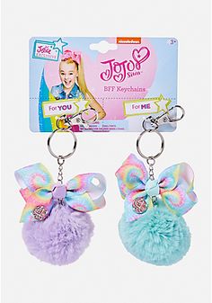 two key chains with pom poms attached to them