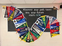 a bulletin board with flags hanging from it's sides in front of a chalkboard