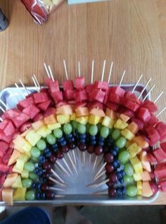 a rainbow made out of fruit and skewers